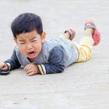 child lying on floor crying